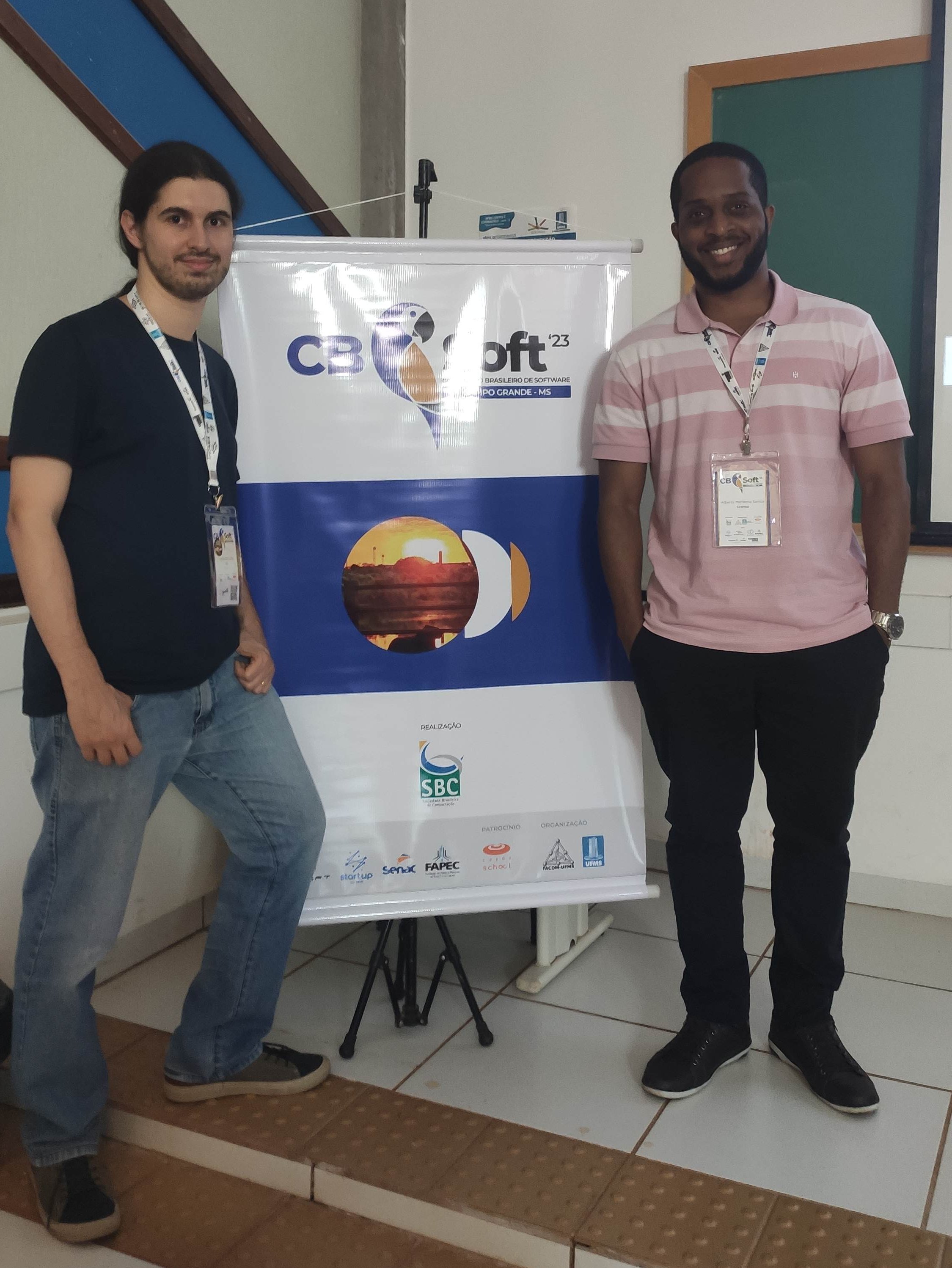 Leonardo and Alberto, presenters of the work, with a CBSoft banner